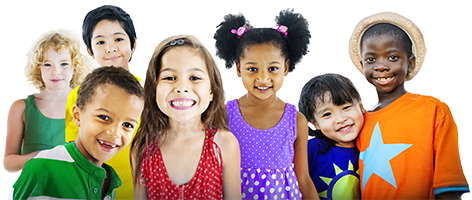 A diverse group of seven cheerful children stand close together, smiling at the camera. They are wearing colorful clothing, including a hat on one child. The background is plain white.